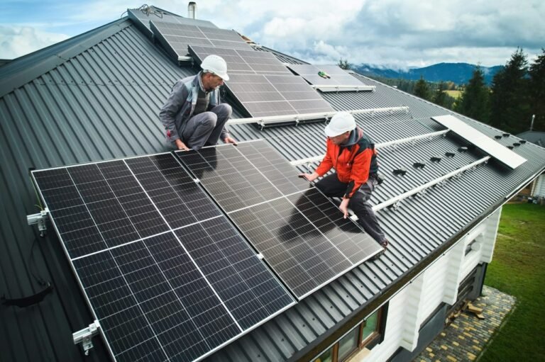 men-workers-installing-solar-panels-on-roof-of-house-